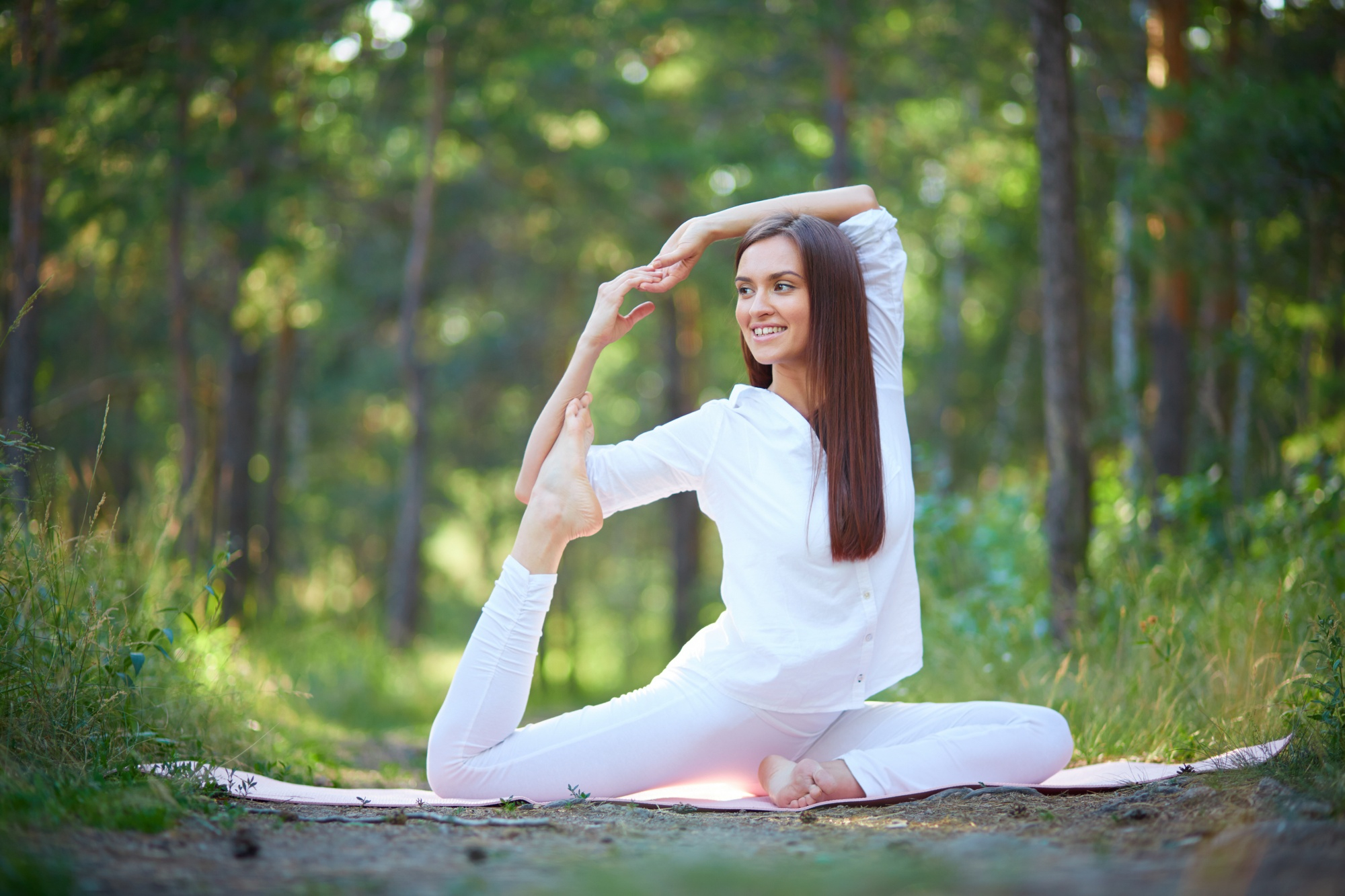 A person practising meditation in a sunlit garden